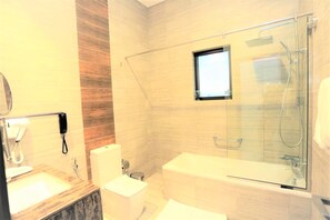 A modern bathroom with a glass shower enclosure, a built-in toilet, and a vanity with a mirror.