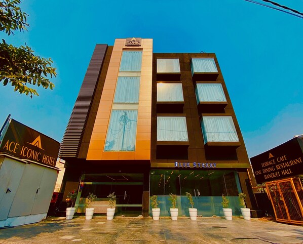 A multi-story building with a prominent "ICONIC" sign at the top. - Ace Iconic (Greater Noida)