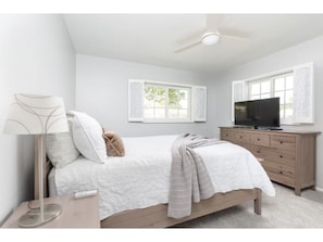 A bedroom with a bed, a dresser, a TV, and a ceiling fan. - ELM - Modern 4BD / Private Pool & Walk to Biltmore (Phoenix)