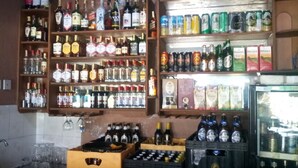 A bar with shelves of liquor bottles and crates of beer. - Blue Perch Lodge (Gilgil)
