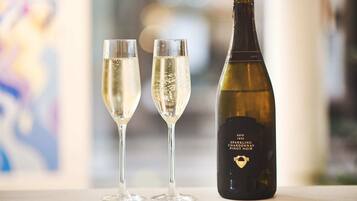 Two champagne flutes and a bottle of 1855 sparkling champagne.