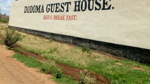 A sign for Dodoma Guest House advertising 'Bed & Break Fast.'