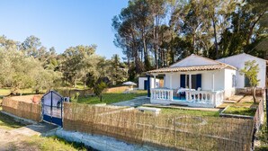 A white villa with a tiled roof, a covered porch, and a fenced garden. - Blue House - Recently renovated (corfu)