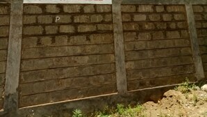 A wooden wall with a sign that reads "MINGI LODGE" and another sign stating "ROOMS AVAILABLE". - Migingo Lodge (Gilgil)