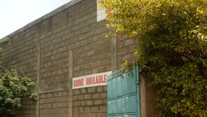A building with a sign stating "ROOMS AVAILABLE" and a gated entrance. - Migingo Lodge (Gilgil)