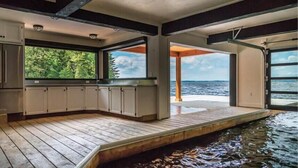 Une cuisine spacieuse, dotée de grandes fenêtres et offrant une vue sur la mer.