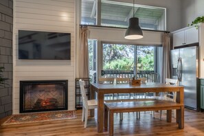 A modern kitchen with a large window, a dining table, and a built-in oven. - Sierra Park Villas #04 (Mammoth Lakes)