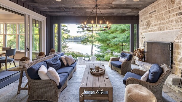 A cozy outdoor seating area with wicker furniture, a wooden coffee table, and a stone fireplace. - 5-year old, Luxury Build on Joe! Immaculate Main + Guest Cottage! Tennis! (Mactier)