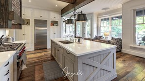 A spacious kitchen with a large island, white cabinetry, and a stainless steel refrigerator. - 5-year old, Luxury Build on Joe! Immaculate Main + Guest Cottage! Tennis! (Mactier)