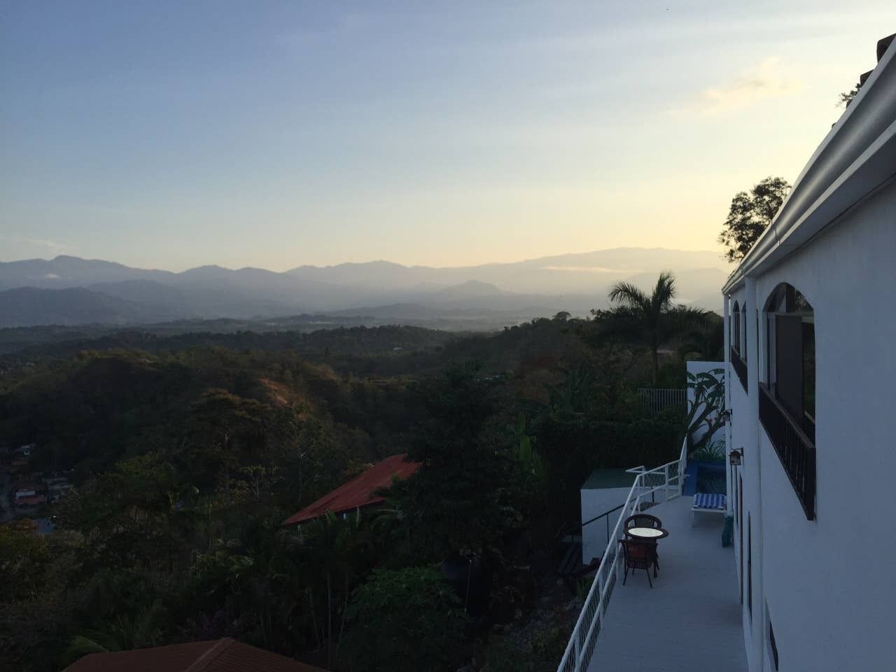 A balcony with a view of a mountainous landscape.
