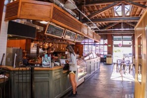 A restaurant interior with a counter, menu boards, and a view of the street outside. - Downtown Spacious Urban Retreat with King Bed! (Spokane)