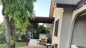 An outdoor patio with brick flooring, a pergola, and outdoor furniture including a table and chairs. - WATER FRONT SWEET HOME (Mesa)