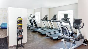 A gym with treadmills and exercise balls.