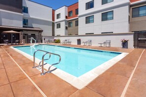 A rectangular pool with a metal ladder, surrounded by a tiled patio. - Residence Inn by Marriott Livermore (Livermore)