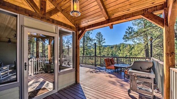 A wooden deck with a glass door leading to a patio area, a grill, and outdoor seating. - Views high above the river with a pleasant walk to Midtown shops and food. (Ruidoso)