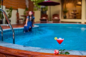 Seasonal outdoor pool, open 8:00 AM to 8:30 PM, pool loungers