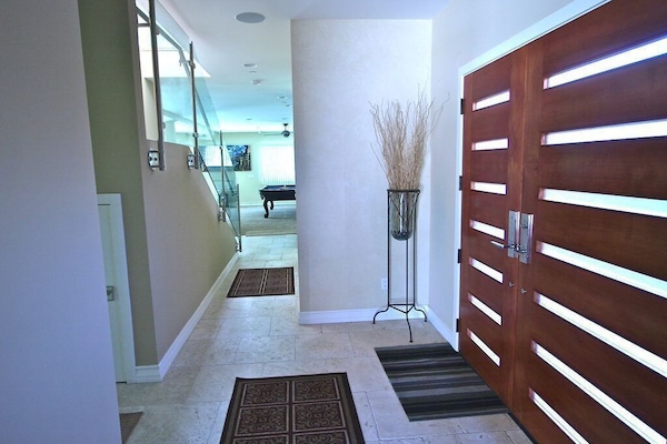 main side entrance with bedroom and bath and large family area and patio.