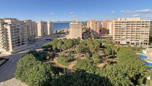 A coastal residential area with high-rise buildings, a clear blue sky, and a view of the sea. - One bedroom apartment in Veneziola (La Manga del Mar Menor)