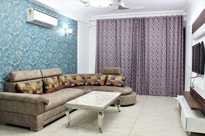 Executive Room | Living area | 30-inch LCD TV with satellite channels, TV, fireplace - Bellagio inn & suites (Gurugram)