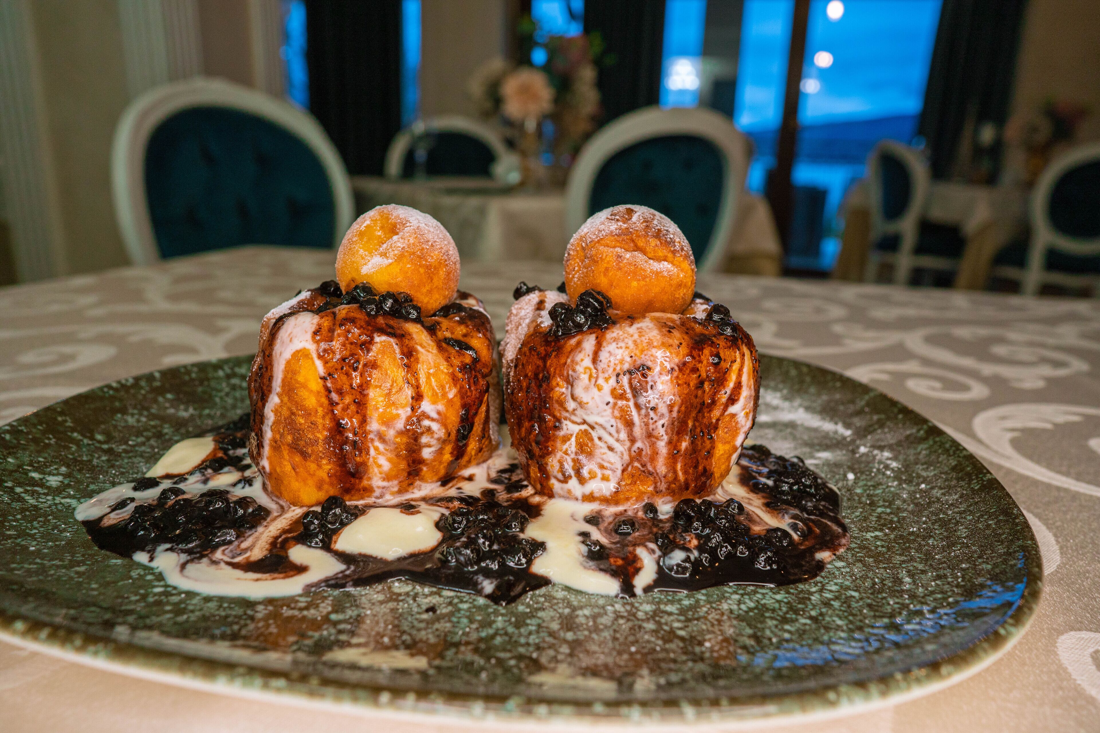 A dessert on a plate with a patterned tablecloth.