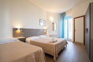 Triple Room, Sea View | Minibar, desk, laptop workspace, blackout drapes