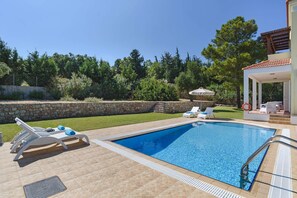 A heated pool, pool loungers