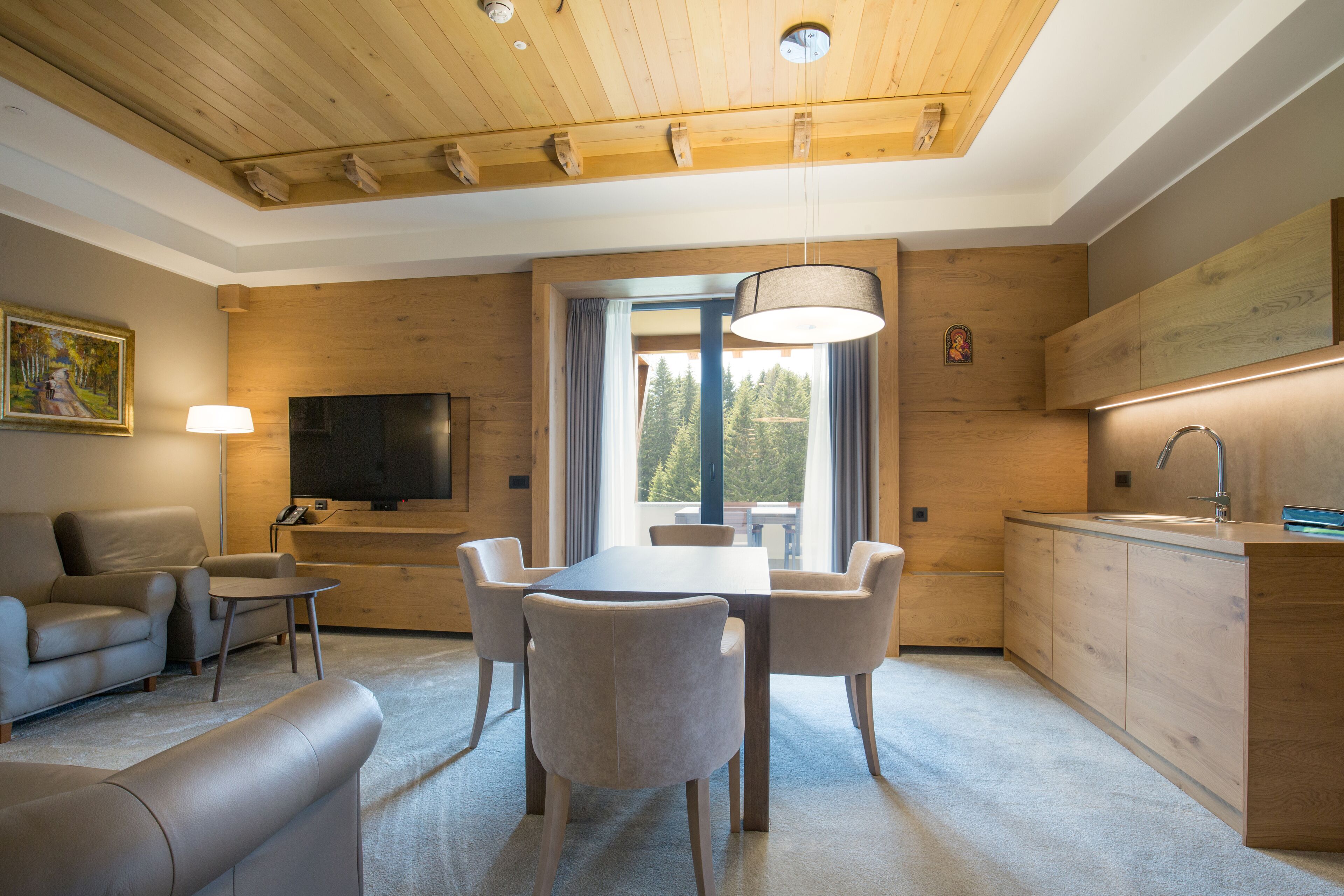 A modern living room with a dining area, wooden ceiling, and a large window with curtains.
