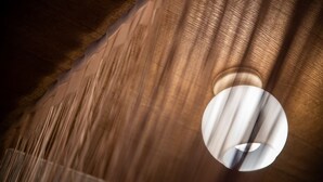 A close-up of a textured wall with a circular light fixture. - A0 Kinshichou 202 (Tokyo)