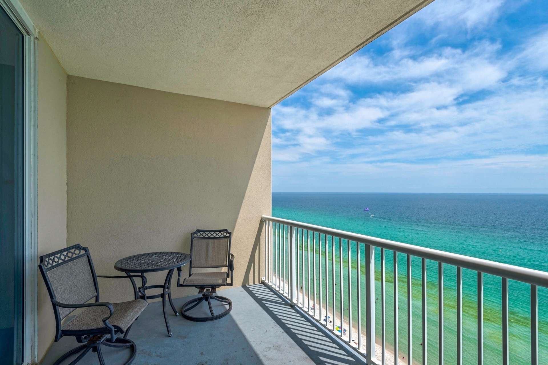 Beachfront resort condo with a private balcony, pool, gym and covered parking