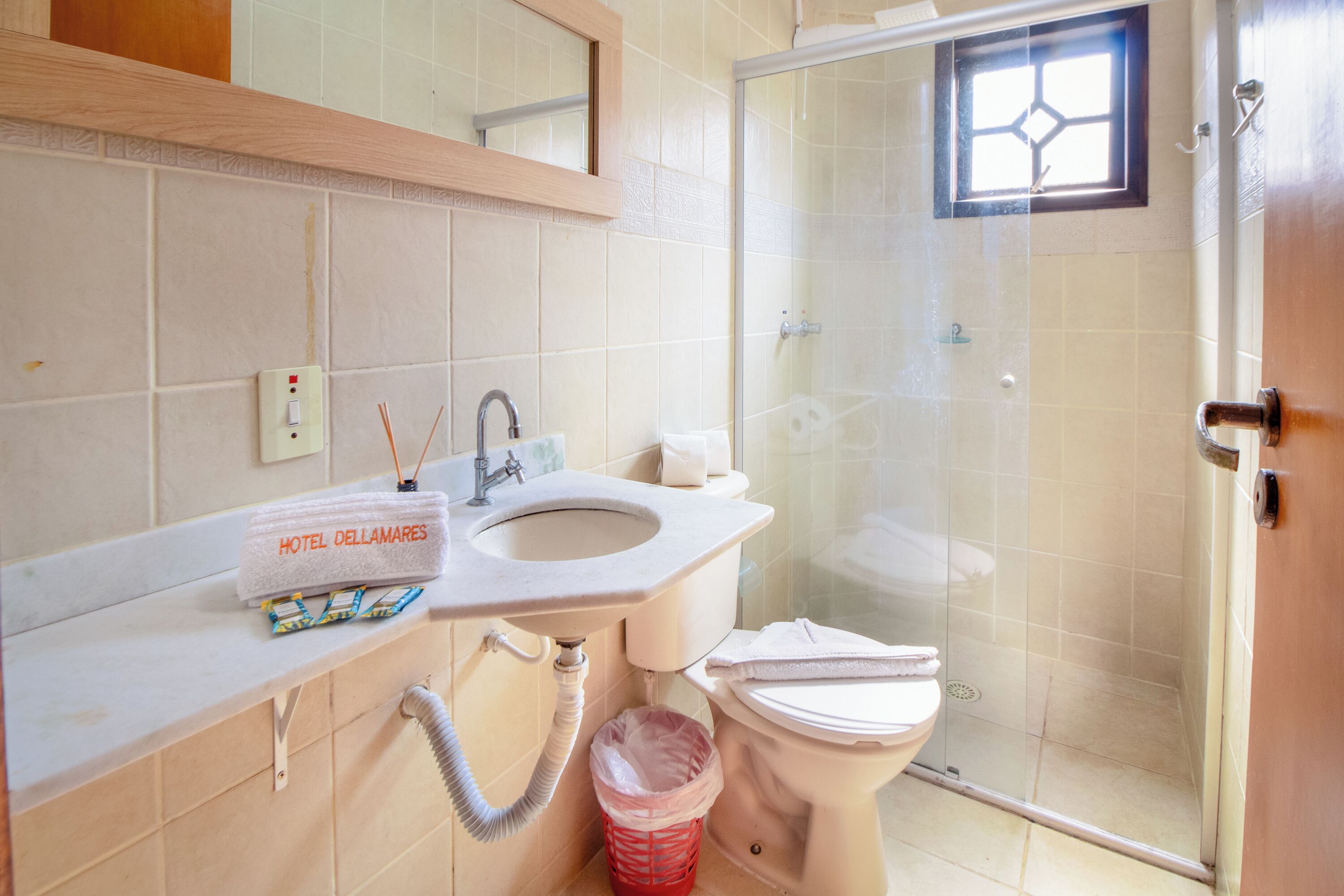 A bathroom with a sink, toilet, and glass-enclosed shower.