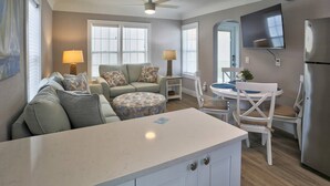 A compact living space with a kitchenette, a dining area, and a seating area with a sofa and chairs. - 1BR Cottage Easy Walk to the Beach! Heated Pool, Kayaks, Bikes, +Tickets to Fun Activities Daily! (Madeira Beach)