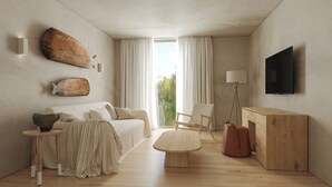 Un salon moderne avec un canapé, une table basse et un téléviseur fixé au mur.