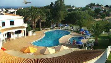 Seasonal outdoor pool, open 8:30 AM to 9:00 PM, pool umbrellas