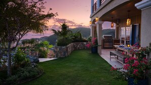 A patio with a grill, outdoor seating, and a view of the landscape. - Sol Inclination~ 4b/4.5b HUGE views, updated in and out, backup power! (St.John)