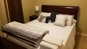 A neatly made bed with patterned bedding, a bedside lamp, and a wooden headboard. - Chicago Style Town home in a gated community!!Spacious 1100sqft (Edinburg)
