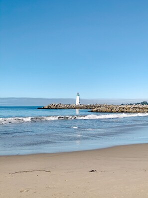 A beach with a lighthouse on a rocky outcrop. - Charming Twin Lakes Beach Cottage (Santa Cruz)