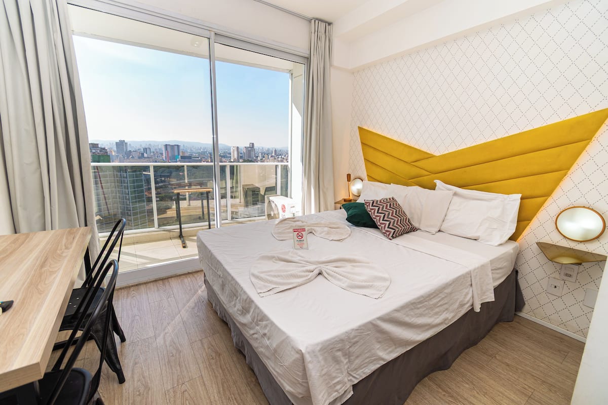 Premium bedding, desk, laptop workspace, blackout drapes