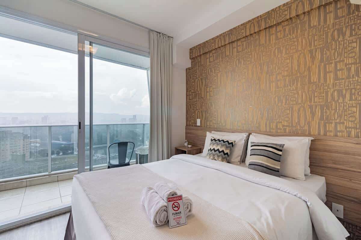 Premium bedding, desk, laptop workspace, blackout drapes