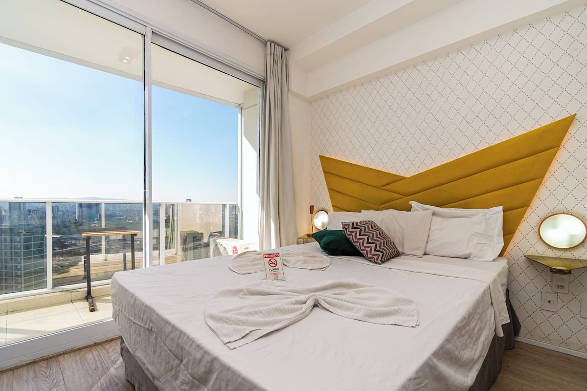 Premium bedding, desk, laptop workspace, blackout drapes