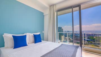 Premium bedding, desk, laptop workspace, blackout drapes