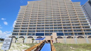 A high-rise hotel with multiple balconies and a prominent entrance. - San Carlos 1001 (Gulf Shores)
