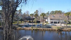 A residential area with a pond, houses, and a playground. - The Colony III 204 - Walk to beach in Surfside Beach (Surfside Beach)