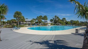 A pool area with lounge chairs and palm trees. - 3-Bed Harbor Island Home with Ocean Views, Pool Access, and Wildlife Watching! (Saint Helena Island)