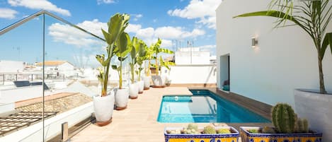 Una piscina al aire libre, tumbonas