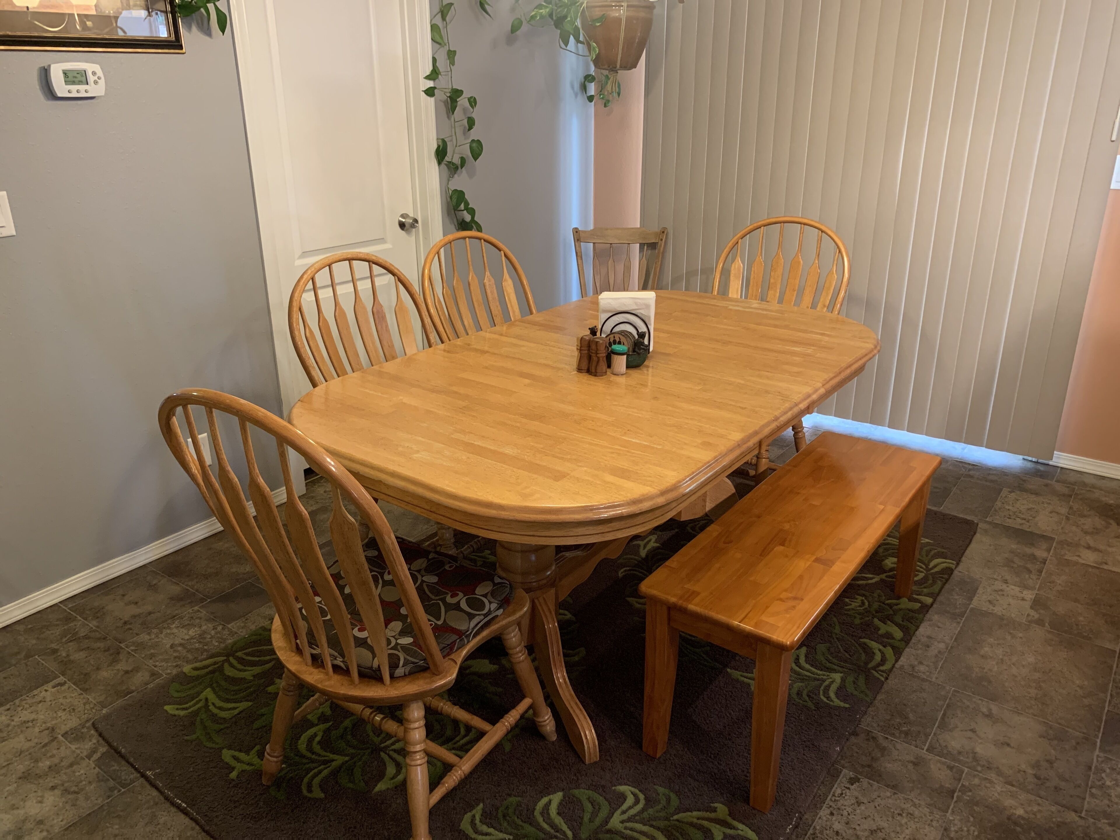Table has hidden leaves and will expand to seat 10 comfortably.