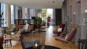 Een moderne woonkamer met een zwarte salontafel, leren banken en een houten vloer.