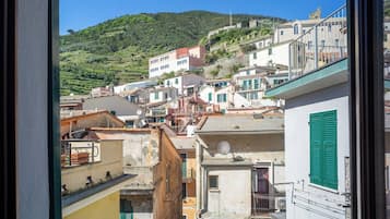 A coastal town with terraced houses, a hillside, and a clear sky.