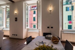 A dining area with a table, chairs, a starfish decoration, and a window with a view of a building.