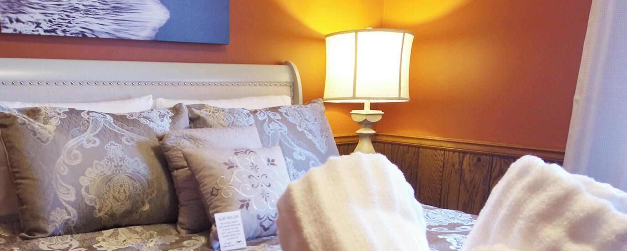 Cozy bedroom retreat with plush bedding and warm lighting