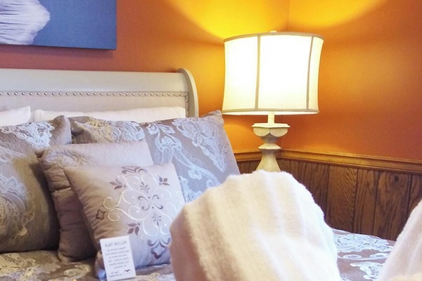 Cozy bedroom retreat with plush bedding and warm lighting
